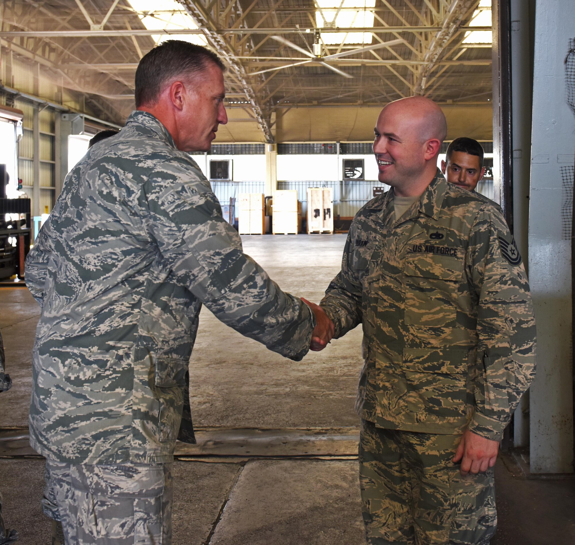 U.S. Air Force Col. David Eaglin (left), 39th Air Base wing commander, coins Tech. Sgt. Sean Durkin, 728th Air Mobility Squadron maintenance training monitor, for superior performance, July 17, 2017 at Incirlik Air Base, Turkey. The 728th AMS provides expertise in three core competencies: aerial port operations, aircraft maintenance, and command and control. (U.S. Air Force photo by Senior Airman Jasmonet D. Jackson)