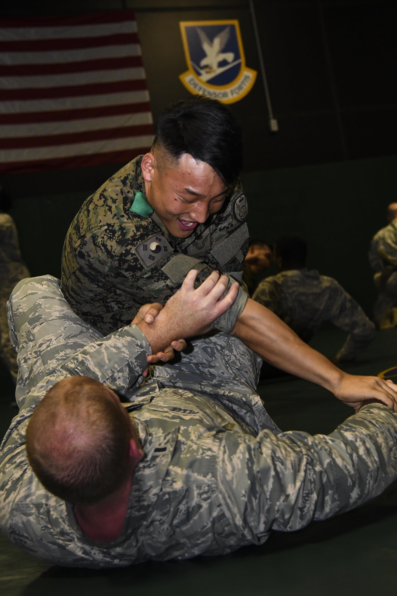 U.S. Air Force 1st Lt. Brett Meece, 51st Security Forces Squadron member, participates in hand to hand combat training with a ROK counterpart during joint combat training at Osan Air Base, Republic of Korea, July 19, 2017. This is the first time this type of joint training has been practiced and was integrated into the Combat Readiness Course, an intensive 10-day course that is held monthly by the 51st SFS. (U.S. Air force photo by Airman 1st Class Gwendalyn Smith)