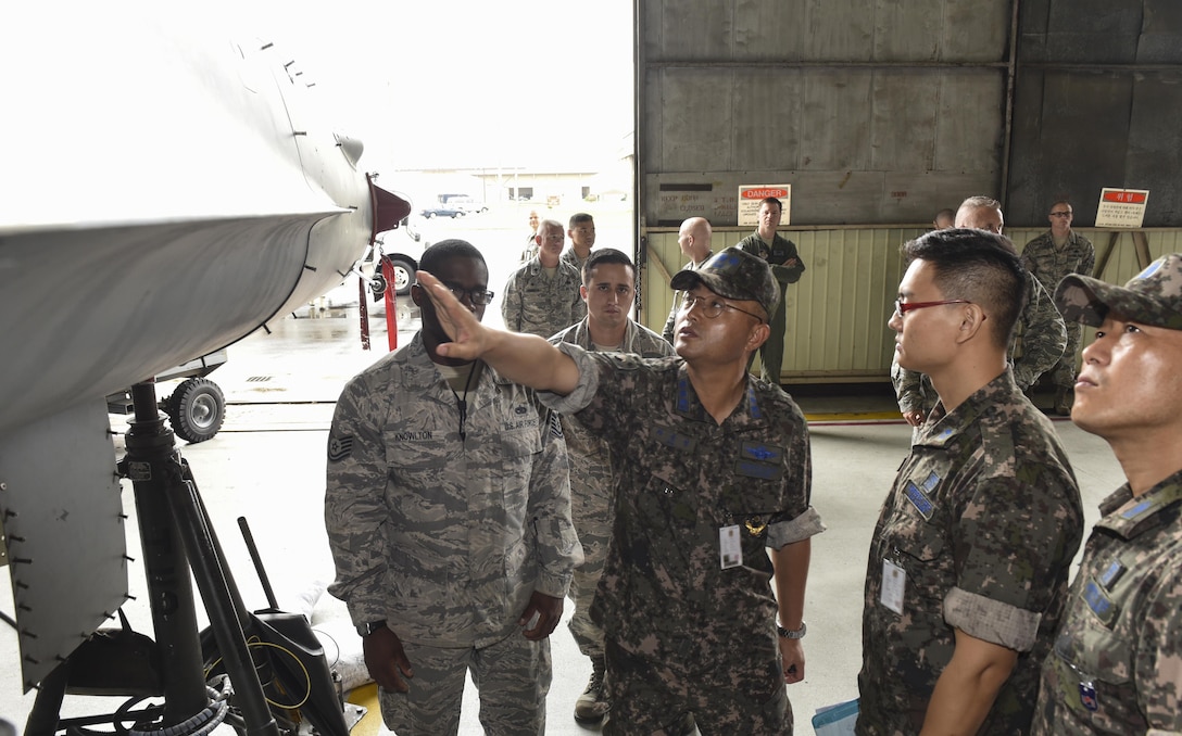 Republic of Korea Air Force Col. Cha, Jun Seon, 38th Fighter Group commander, inspects an F-16 Fighting Falcon during a corrosion control brief at Kunsan Air Base, ROK, July 18, 2017. Cha participated in an immersion that allowed him to see U.S. and ROKAF capabilities and what they can do to strengthen their relationship. (U.S. Air Force photo by Senior Airman Michael Hunsaker)