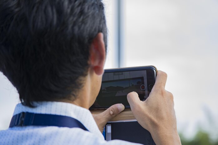A Japanese local takes video of the scoreboard lighting during a ceremony for the upcoming completion of Kizuna Stadium in Iwakuni City, Japan, July 19, 2017. Following the scoreboard lighting, attendees witnessed the first pitch by Takahiro Sugawara, director general of Chugoku-Shikoku Defense Bureau and toured the stadium. (U.S. Marine Corps photo by Cpl. Joseph Abrego)
