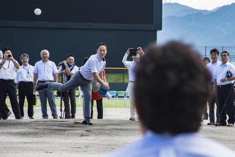 Yoshihiko Fukuda, mayor of Iwakuni City, pitches a baseball during a scoreboard lighting ceremony at Kizuna Stadium in Iwakuni City, Japan, July 19, 2017. Following the scoreboard lighting, Takahiro Sugawara, director general of Chugoku-Shikoku Defense Bureau, U.S. Marine Corps Col. Richard F. Fuerst, commanding officer of Marine Corps Air Station Iwakuni, and Fukuda threw the very first pitches at the stadium. (U.S. Marine Corps photo by Cpl. Joseph Abrego)