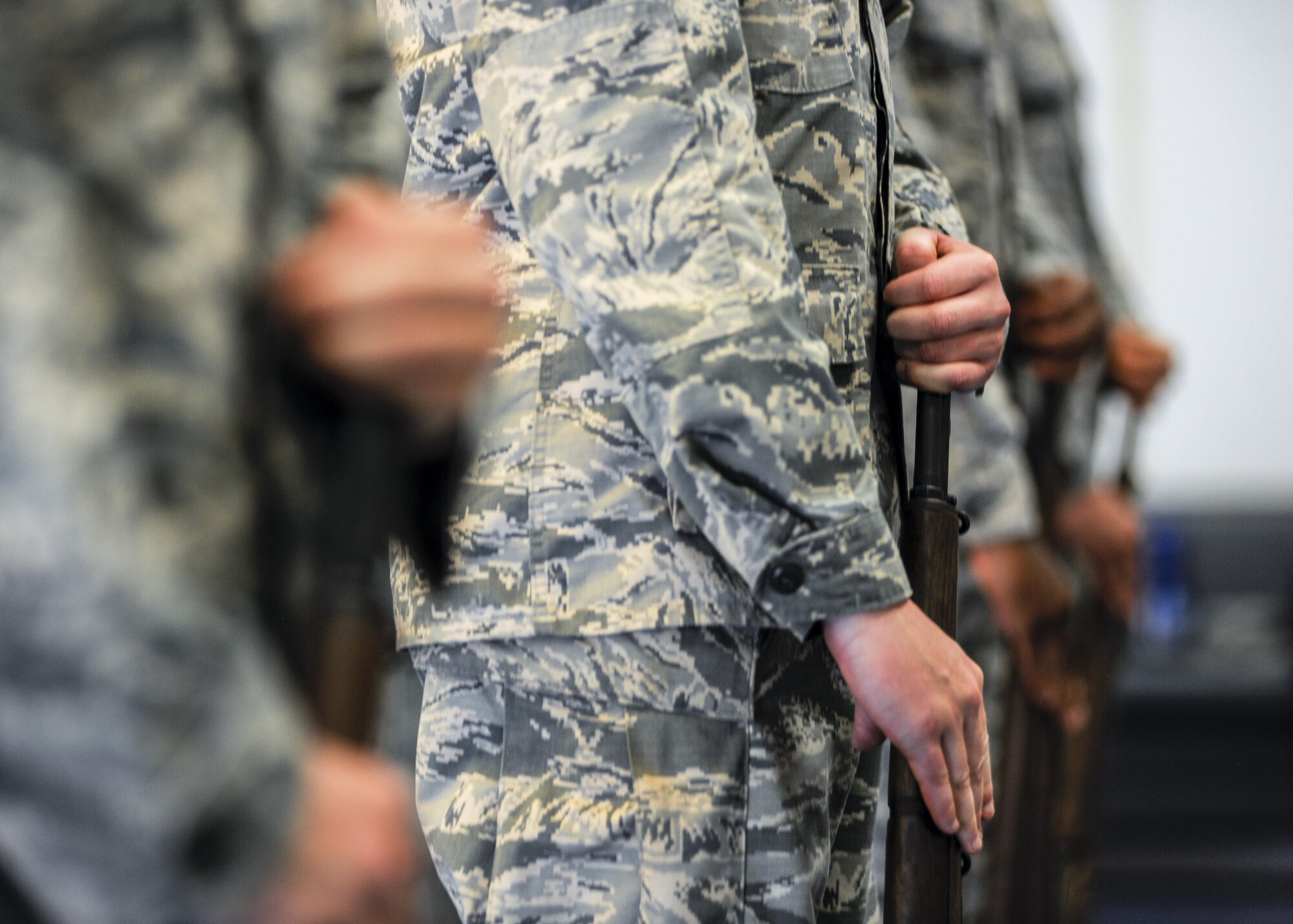 Airmen position their rifles during a during a base honor guard practice July 10, 2017, at Aviano Air Base, Italy. Honor guardsmen must master rifle movements before performing in their first military ceremony. (U.S. Air Force photo by Senior Airman Cory W. Bush)