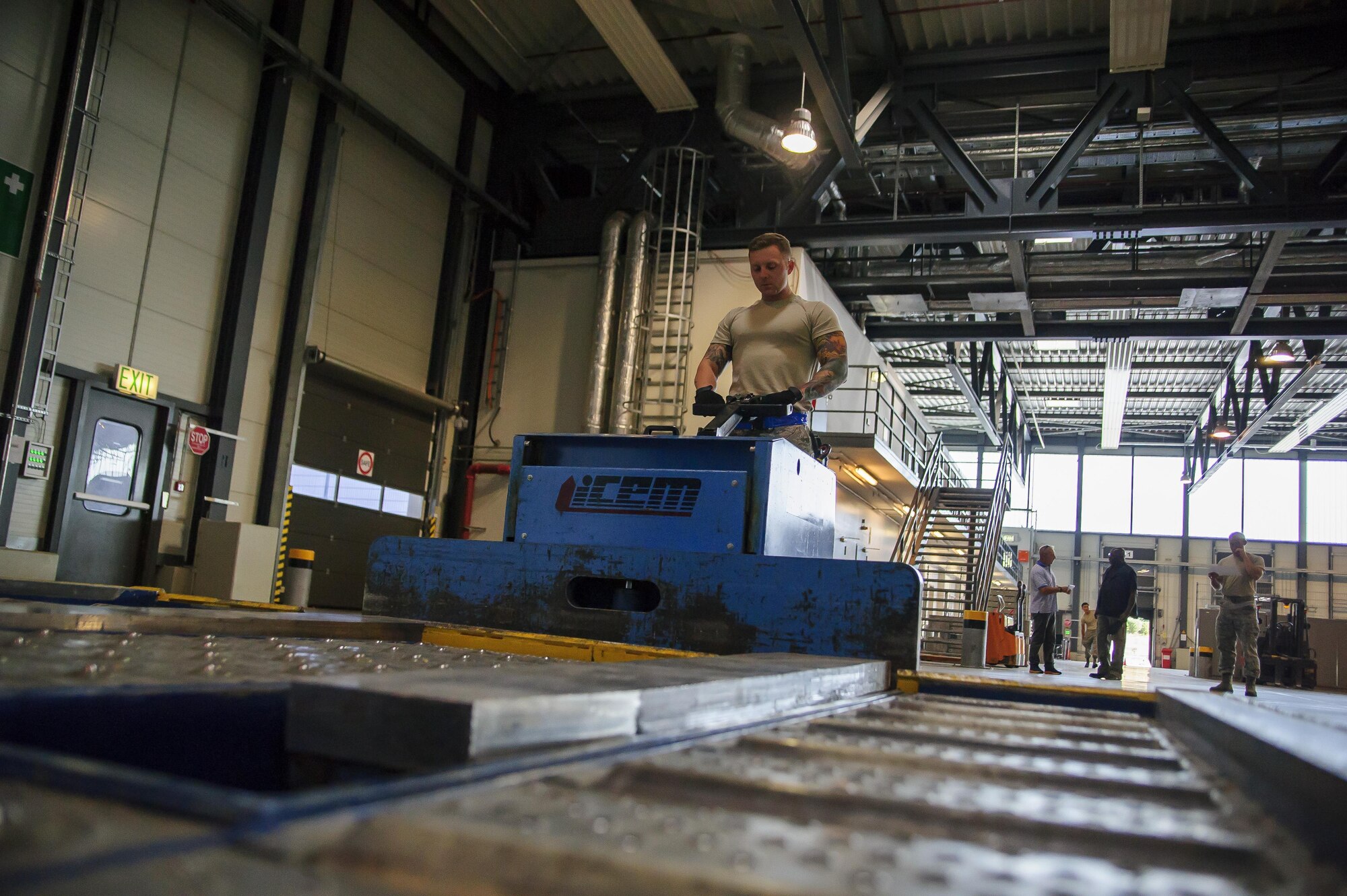 Tech. Sgt. William Anderson, an Airman from the 81st Aerial Port Squadron, Joint Base Charleston, conducts off-station annual training in the special handling section at Ramstein Air Base, Germany, July 19, 2017. Anderson’s use of this ICEM pallet mover, nicknamed “Blue Goose,” allows him to move large pallets of cargo with ease. (U.S. Air Force photo by Senior Airman Jonathan Lane)