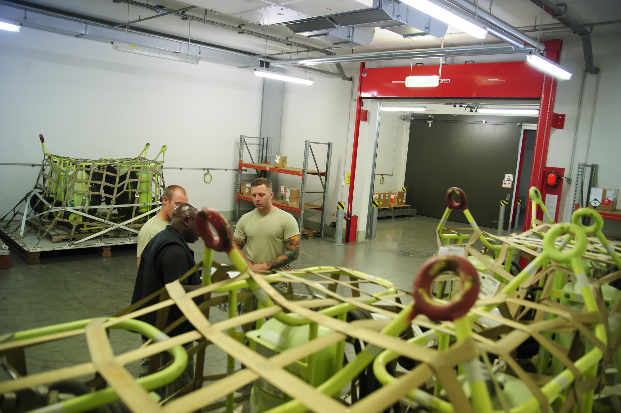 Tech. Sgt. William Anderson, an Airman from the 81st Aerial Port Squadron, Joint Base Charleston, inspect a pallet of HALON fire extinguishers for proper markings, labels and weight in the special handling section at Ramstein Air Base, Germany, July 19, 2017.  Anderson, along with fellow Airman from the 81st APS, completed annual tour training requirements while in Germany. (U.S. Air Force photo by Senior Airman Jonathan Lane)