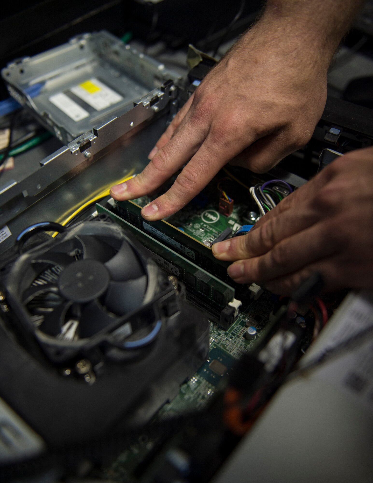 U.S. Air Force Senior Airman Andrew Montz, a cyber transport technician with the 379th Expeditionary Communication Squadron, replaces the main board at Al Udeid Air Base, Qatar, July 14, 2017. Montz is responsible for installing programs, troubleshooting and repairing computer problems, and ensuring that all of the hardware and software systems are functional. (U.S. Air Force photo by Tech. Sgt. Amy M. Lovgren)