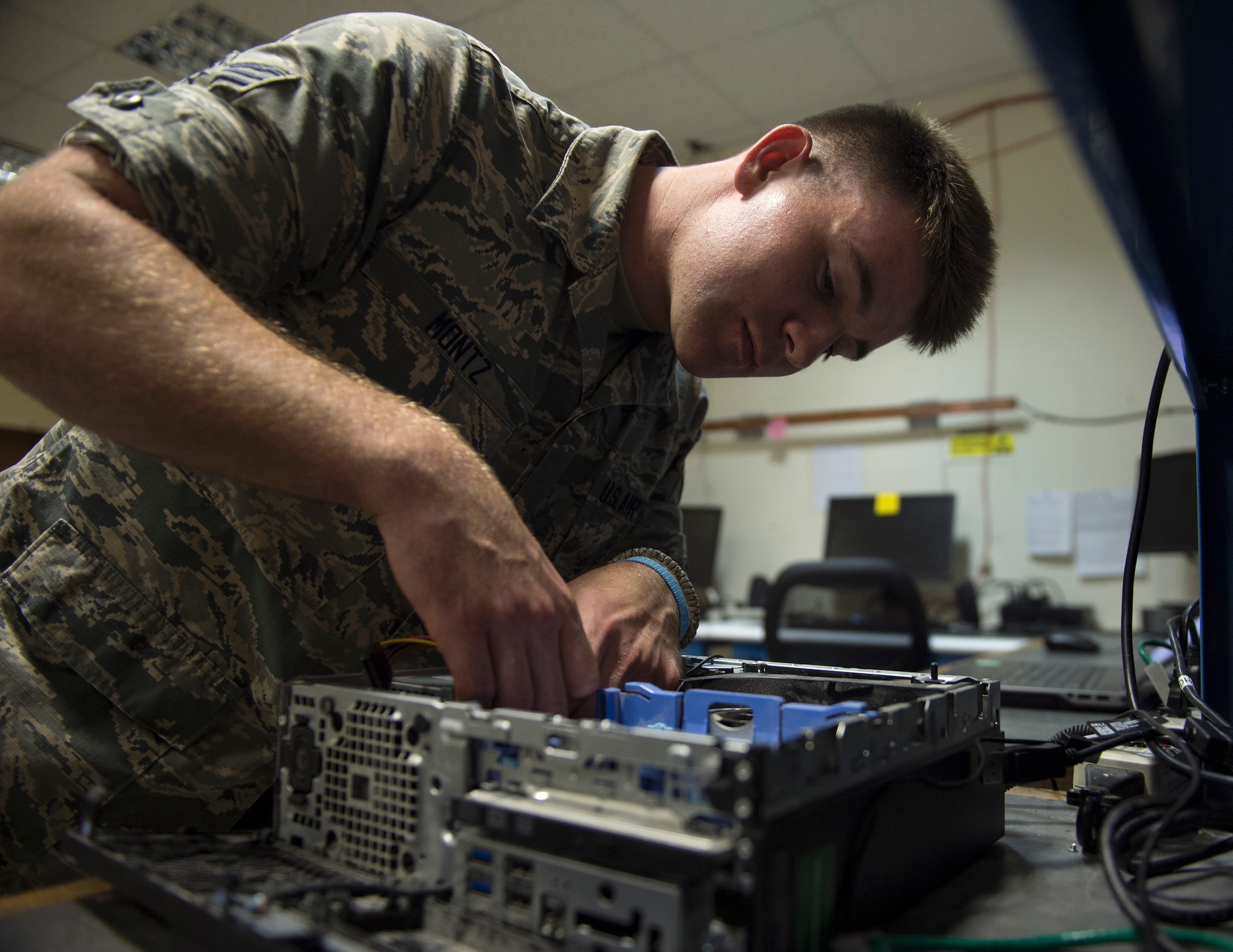U.S. Air Force Senior Airman Andrew Montz, a cyber transport technician with the 379th Expeditionary Communication Squadron, repairs a desktop computer at Al Udeid Air Base, Qatar, July 14, 2017. Montz is responsible for installing programs, troubleshooting and repairing computer problems, and ensuring that all of the hardware and software systems are functional. (U.S. Air Force photo by Tech. Sgt. Amy M. Lovgren)