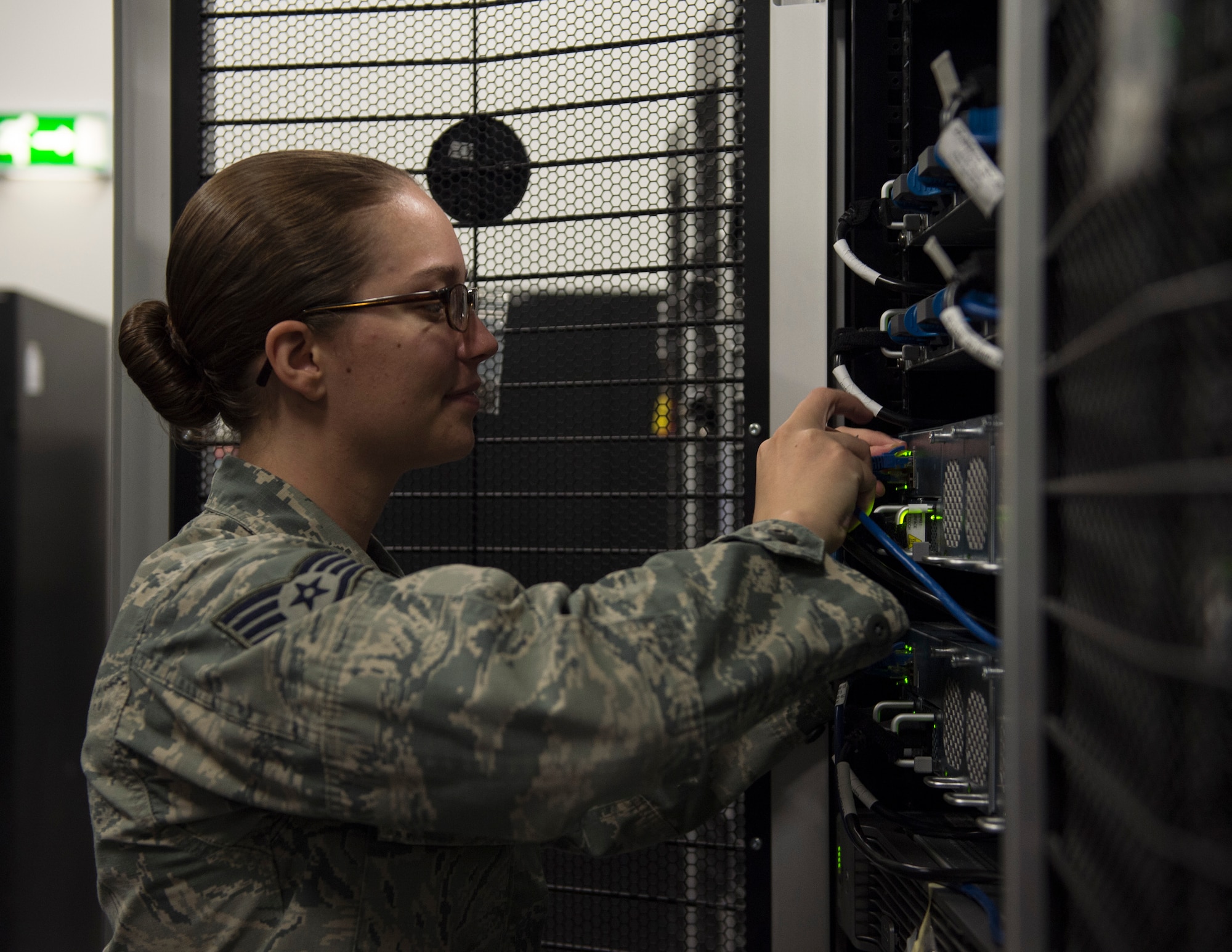 U.S. Air Force Staff Sgt. Shelby Carter, 379th Expeditionary Communication Squadron, checks a network server at Al Udeid Air Base, Qatar, July 14, 2017. Carter is part of a team of Airmen which are responsible for installing and supporting all network servers ensuring they are operational and secure from outside intrusion. (U.S. Air Force photo by Tech. Sgt. Amy M. Lovgren)