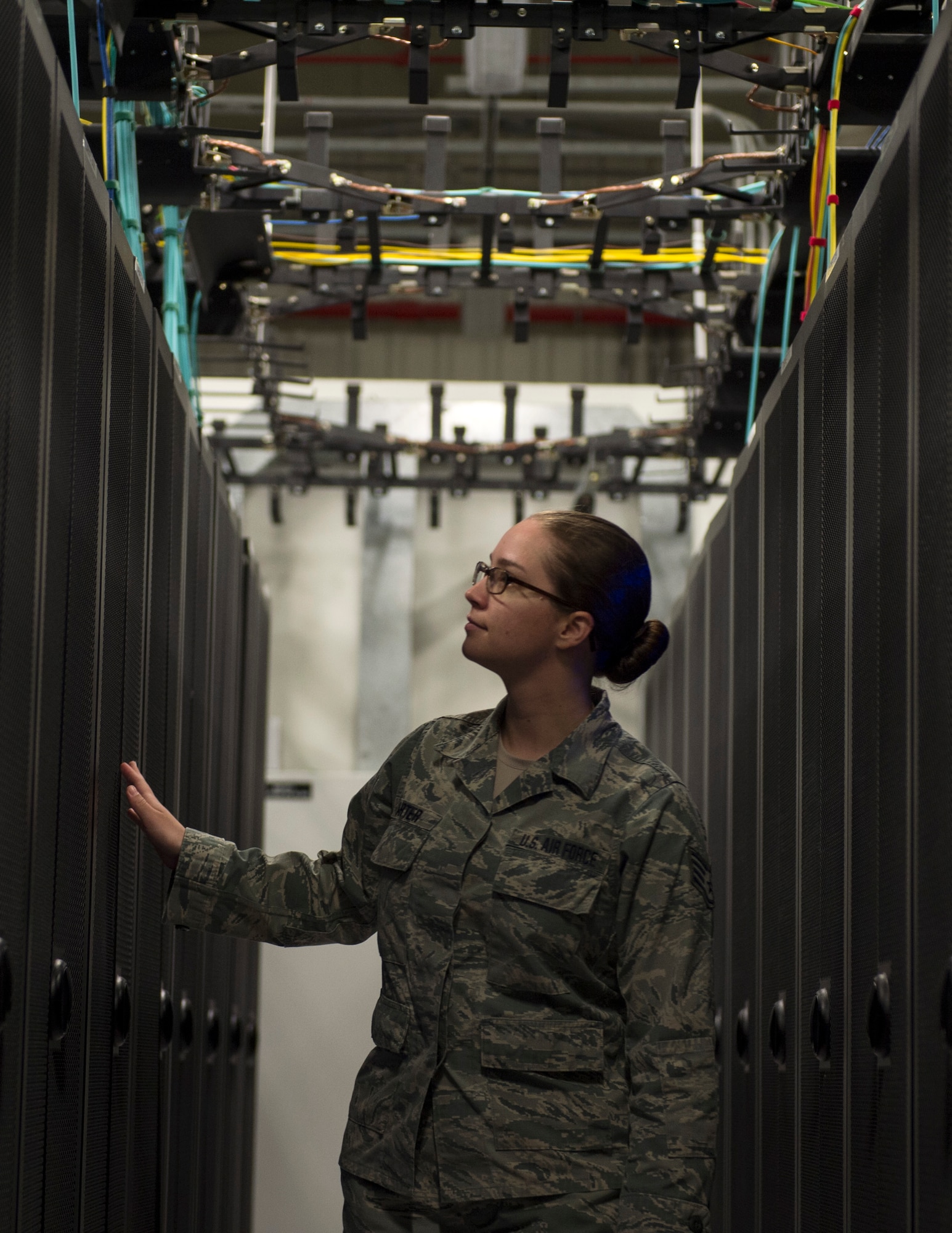 U.S. Air Force Staff Sgt. Shelby Carter, 379th Expeditionary Communication Squadron, checks the network servers for signs of problems at Al Udeid Air Base, Qatar, July 14, 2017. Carter is part of a team of Airmen which are responsible for installing and supporting all network servers by ensures they are operational and secure from outside intrusion. (U.S. Air Force photo by Tech. Sgt. Amy M. Lovgren)