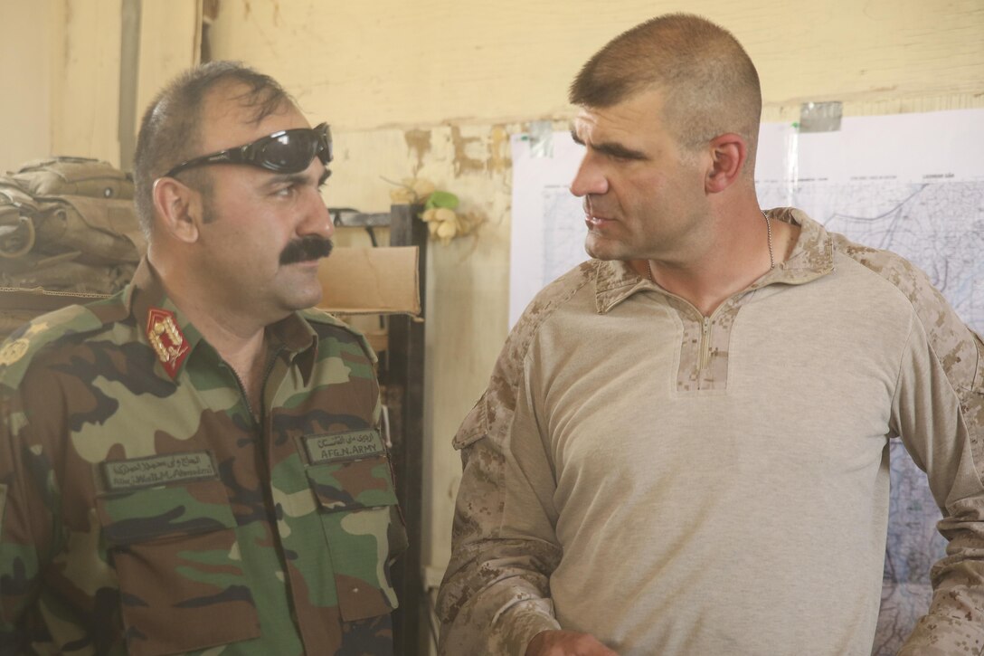 Afghan National Army Brig. Gen. Ahmadzai, left, the commanding general of 215th Corps, speaks with U.S. Marine Col. Matthew Grosz, right, the senior ANA advisor assigned to Task Force Southwest, at Camp Shorserack, Afghanistan, July 14, 2017. Elements of the Afghan National Defense and Security Forces, including the 215th Corps and 505th Zone National Police, successfully cleared the Nawa district center of insurgent presence during Operation Maiwand Four with assistance from Marine advisors, and will continue to provide security and work to establish governance in the area. (U.S. Marine Corps photo by Sgt. Lucas Hopkins)