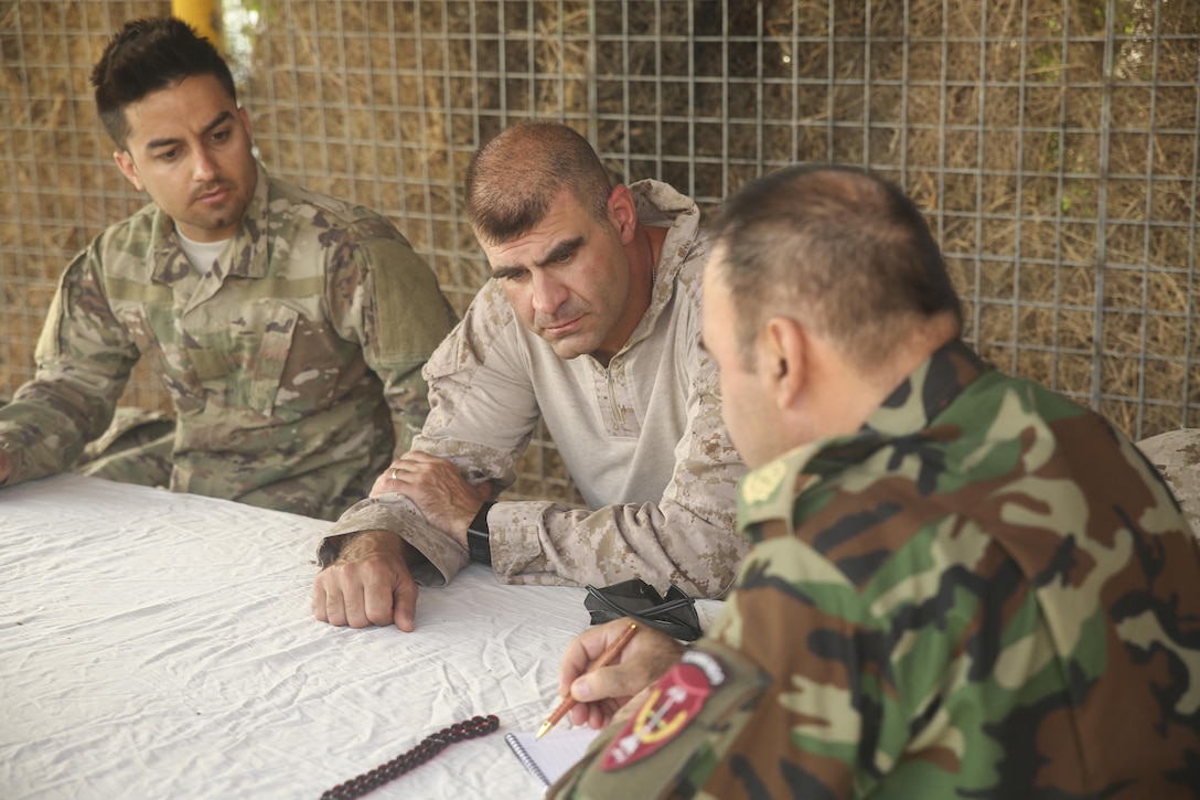 U.S. Marine Col. Matthew Grosz, center, the senior Afghan National Army 215th Corps advisor with Task Force Southwest, speaks with Brig. Gen. Ahmadzai, right, the commanding general of the 215th Corps, at Camp Shorserack, Afghanistan, July 15, 2017. The Task Force advised and provided assistance through battle-tracking and air support to their Afghan National Defense and Security Force counterparts during Operation Maiwand Four. Several elements of ANDSF, including the 215th Corps, 505th Zone National Police and Afghan Border Police, worked together to clear the Nawa district center of insurgents and help establish governance in the area. (U.S. Marine Corps photo by Sgt. Lucas Hopkins)