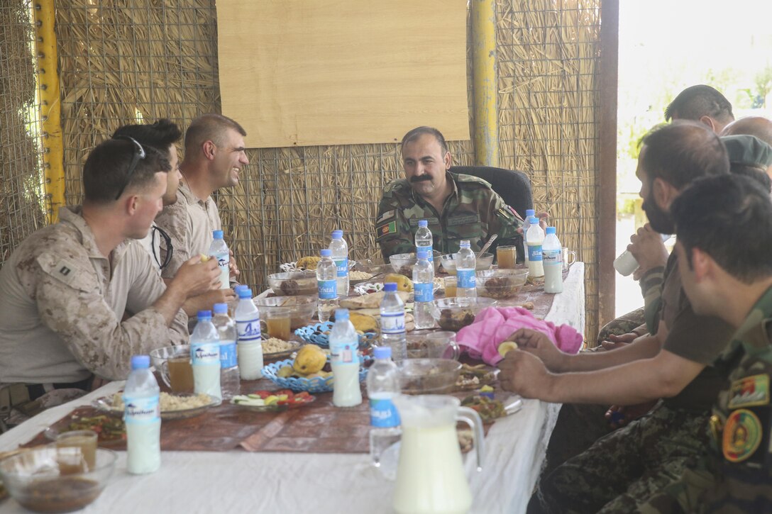 Afghan National Army soldiers with 215th Corps and U.S. Marine advisors with Task Force Southwest have lunch and discuss strategy during Operation Maiwand Four at Camp Shorserack, Afghanistan, July 16, 2017. Several advisors with the Task Force advised and provided battle-tracking assistance for their Afghan National Defense and Security Force counterparts throughout the operation. Elements of the Afghan National Army, Afghan National Police and other forces came together to clear the Nawa district center of insurgents. (U.S. Marine Corps photo by Sgt. Lucas Hopkins)