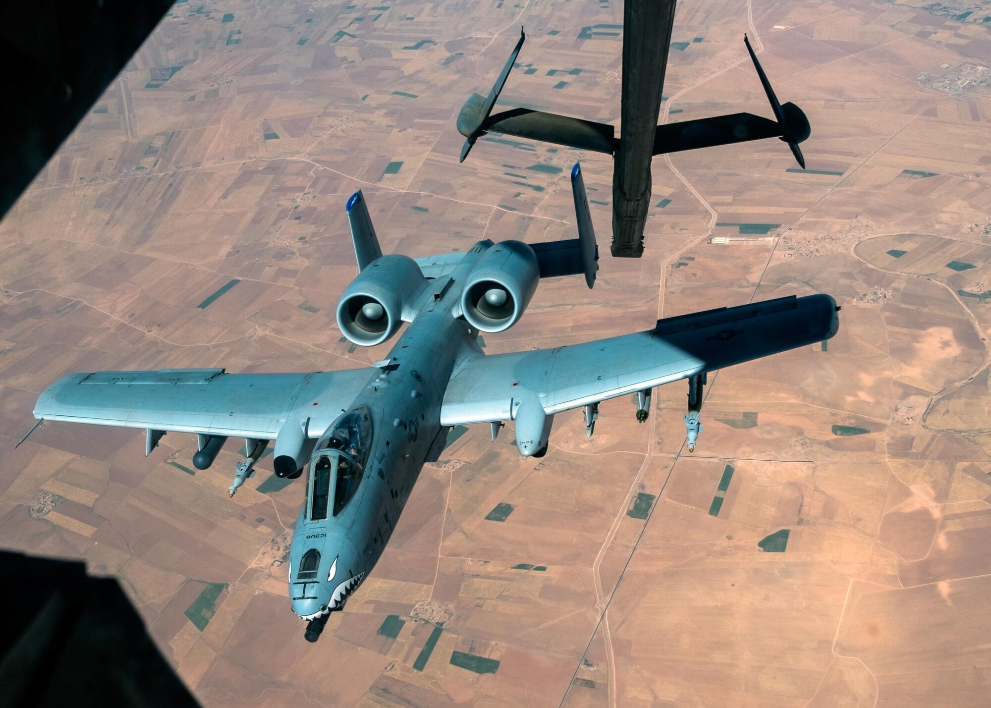 An A-10 Thunderbolt II departs after receiving fuel from a KC-10 Extender with the 908th Expeditionary Air Refueling Squadron July 19, 2017, over an undisclosed location in southwest Asia. The A-10 can employ a wide variety of conventional munitions and the GAU-8/A 30mm cannon, capable of firing 3,900 rounds per minute to defeat a wide variety of targets including tanks. (U.S. Air Force photo by Senior Airman Preston Webb)