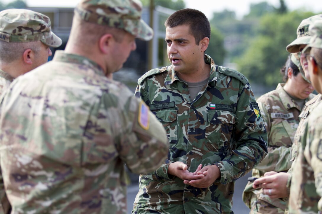 A Bulgarian Civil Military Cooperation partner speaks with soldiers from 361st Civil Affairs Brigade prior to the 2nd Cavalry Regiment bridge crossing in Ruse, Bulgaria, July 17 (U.S. Army Reserve photo by Capt. Jeku Arce, 221st Public Affairs Detachment).