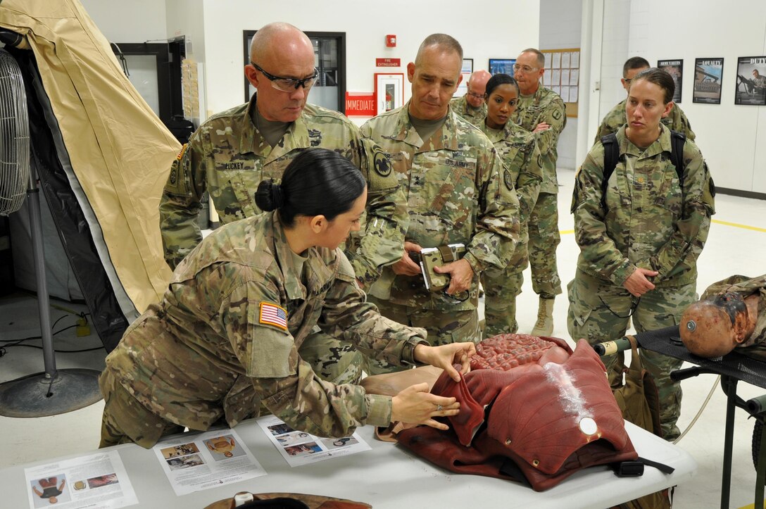 Capt. Vanessa Lagrange, Medical Training OIC, shows the various prosthetics used during training in the medical treatment facility portion to with LTG Charles D. Luckey, Chief of Army Reserve and Commanding General, United States Army Reserve Command, while touring the Sustainment Training Center at Camp Dodge Joint Maneuver Training Center in Johnston, Iowa on July 19, 2017. (U.S. Air National Guard photo by Tech. Sgt. Michael McGhee/Released)