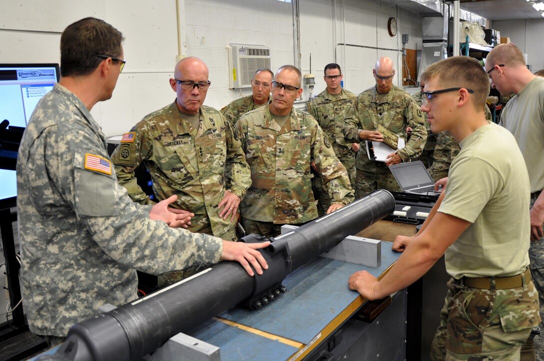 LTG Charles D. Luckey, Chief of Army Reserve and Commanding General, United States Army Reserve Command, and Maj. Gen. Timothy Orr, Adjutant General of the Iowa National Guard, receive a briefing from CW2 Matthew Tormey, Armament Systems Maintenance Warrant Officer, on the maintenance procedures of the M120 Mortar Weapon while touring the Sustainment Training Center at Camp Dodge Joint Maneuver Training Center in Johnston, Iowa on July 19, 2017.  (U.S. Air National Guard photo by Tech. Sgt. Michael McGhee/Released)