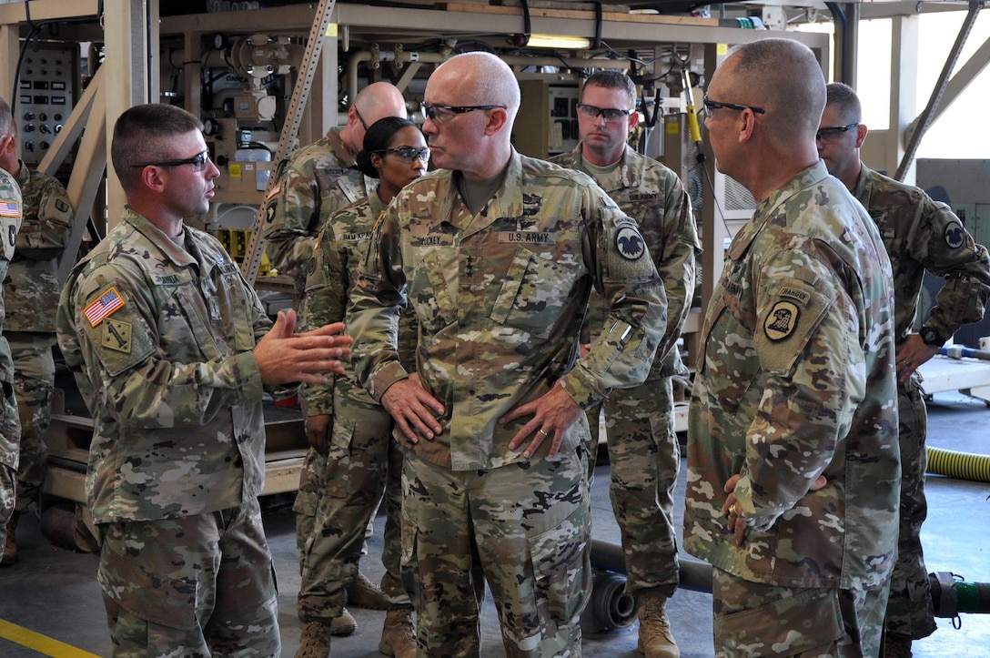 CW3 Jack Canida, Warrant Officer in Charge - Ground Support Equipment, explains the process of the Tactical Water Purification System and equipment repair to LTG Charles D. Luckey, Chief of Army Reserve and Commanding General, United States Army Reserve Command, and Maj. Gen. Timothy Orr, Adjutant General of the Iowa National Guard, as they tour the Sustainment Training Center at Camp Dodge Joint Maneuver Training Center in Johnston, Iowa on July 19, 2017. (U.S. Air National Guard photo by Tech. Sgt. Michael McGhee/Released)