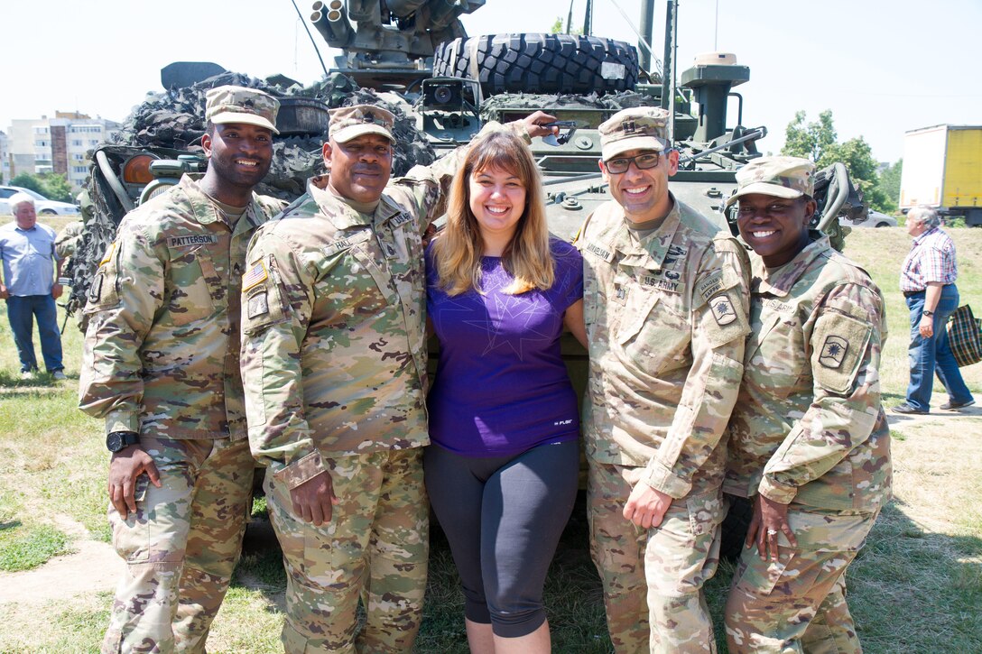 Soldiers of 361st Civil Affairs Brigade pose for a photo with locals of Ruse, Bulgaria at a static display of 2nd Cavalry Regiment strykers and Bulgarian military vehicles, July 17 (U.S. Army Reserve photo by Capt. Jeku Arce, 221st Public Affairs Detachment).