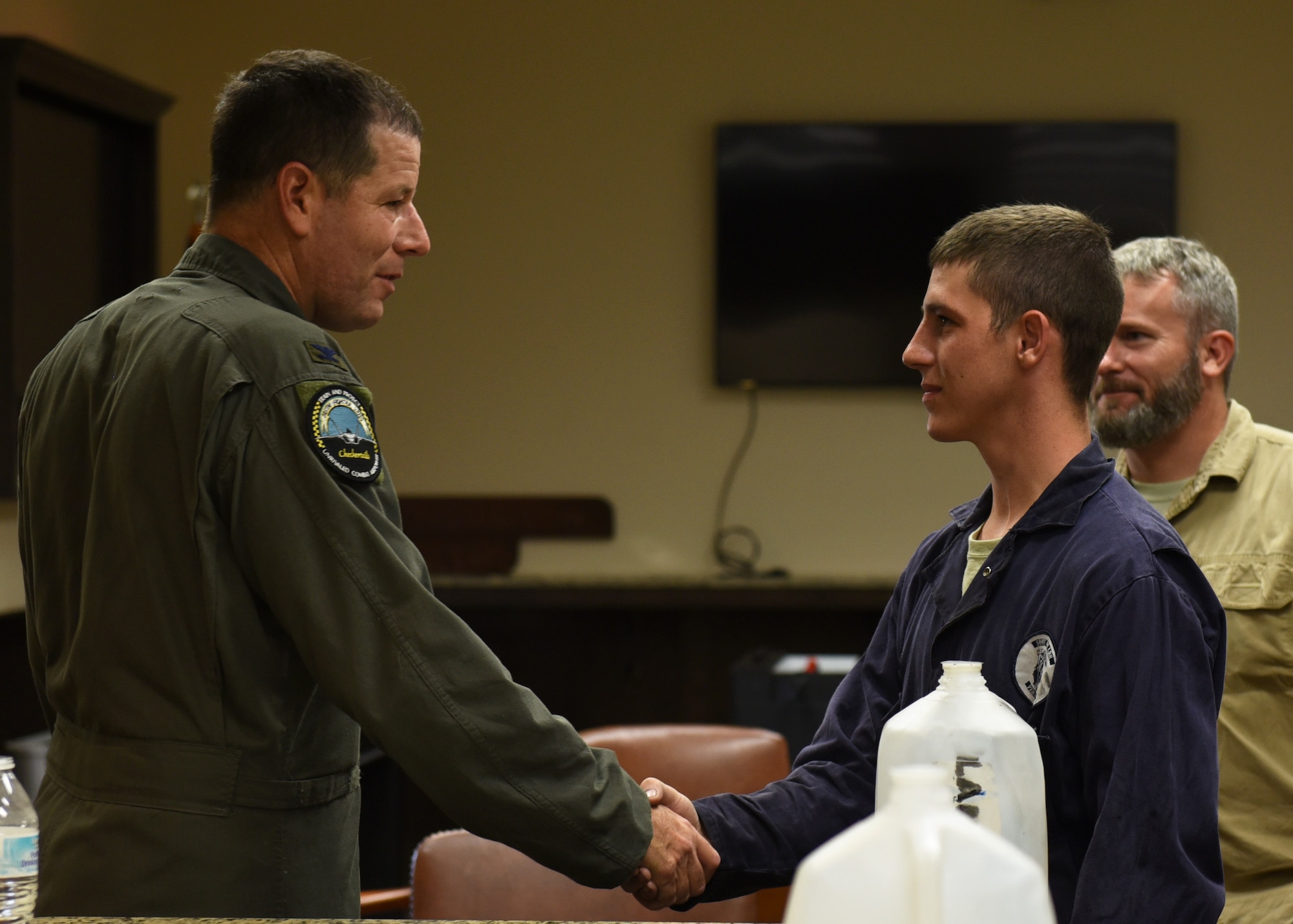 U.S. Air Force Col. Michael Hernandez, 325th Fighter Wing commander (left), thanks Senior Airman Curtis Lampert, 325th Logistics Readiness Squadron firefighting and refueling vehicle equipment maintenance journeyman (right), for showing him his daily job duties at Tyndall Air Force Base, Fla., July 7, 2017. Lampert showed Hernandez what the duties of his position entailed after he was selected by his leadership to participate in the Airman Shadow Program. 