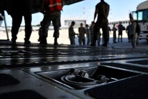 Airmen assisting a patient move wait as patients exit ambulance buses on Ramstein Air Base, Germany, July 13, 2017. The En-Route Patient Staging Facility personnel aide as patient movement care takers for injured service members in transit to the continental United States. (U.S. Air Force photo by Airman 1st Class D. Blake Browning)