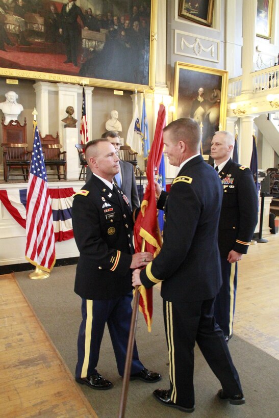 U.S. Army Maj. Gen. Kent Savre, commanding general, Maneuver Support Center of Excellence and Fort Leonard Wood, Mo., passes the Corps flag to Col. William Conde, the incoming district engineer and commander of U.S. Army Corps of Engineers New England District during a change of command ceremony at the historic Faneuil Hall, in Boston, Mass., July 19, 2017. Conde assumed command as the district engineer and commander from Col. Christopher Barron. (U.S. Army photo by Diallo Ferguson/Released)