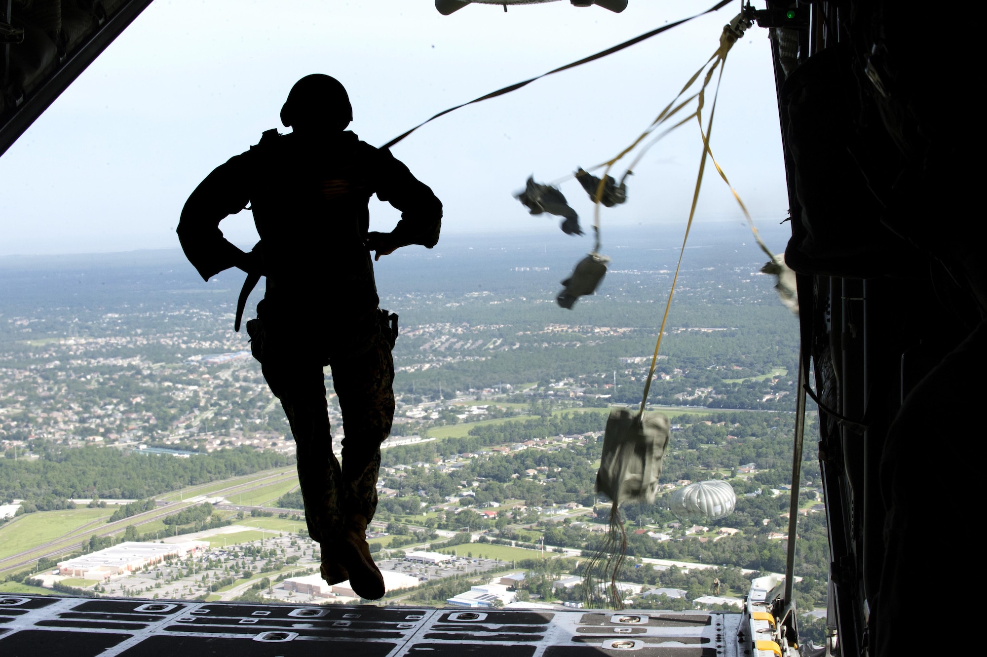 A U.S. Army service member assigned to MacDill Air Force Base, Fla., jumps out of a C-130 Hercules Aircraft over Brooksville, Fla., during a training mission, July 15, 2017. The training missions purpose was to update service members jump qualifications. (U.S Air Force Photo by Airman 1st Class Rito Smith)