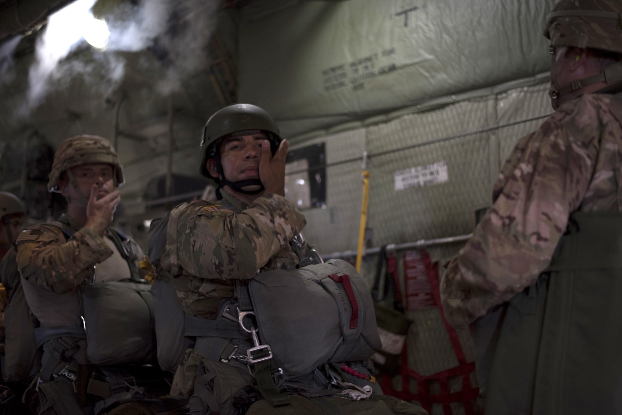 U.S. Army Service members assigned to MacDill Air Force Base, Fla., check their gear before jumping out of a C-130 Hercules Aircraft over Brooksville, Fla., July 15, 2017. Before every jump, the service members check all of their gear to ensure they can safely jump. (U.S Air Force Photo by Airman 1st Class Rito Smith)