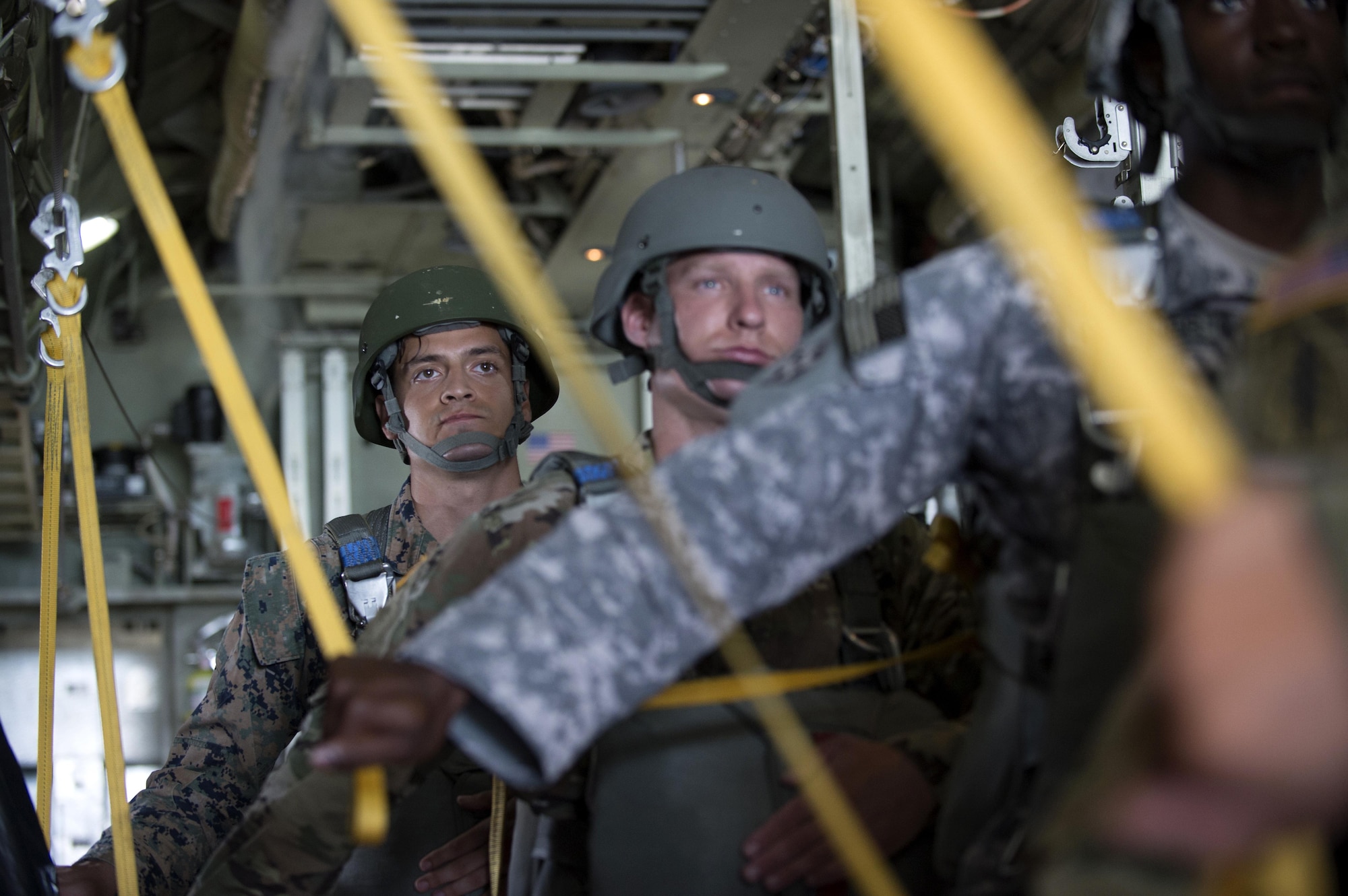 U.S. Army Service members assigned to MacDill Air Force Base, Fla., stand up and prepare to jump out of a C-130 Hercules Aircraft over Brooksville, Fla., July 15, 2017. Once given the go ahead by the jumpmaster, service members prepare to perform gear checks. (U.S Air Force Photo by Airman 1st Class Rito Smith)