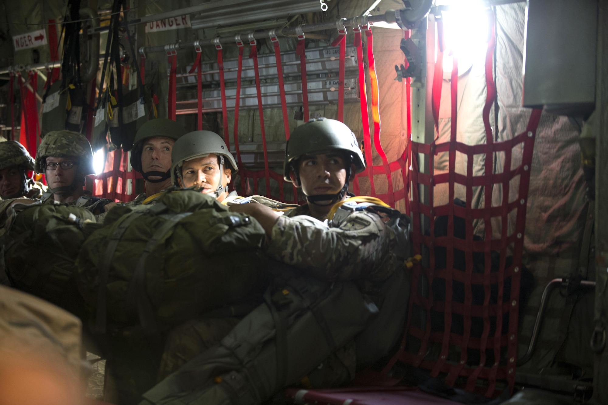 U.S. Army Service Members assigned to MacDill Air Force Base, Fla., look in anticipation of their turn to jump out of a C-130 Hercules Aircraft over Brooksville, Fla., July 15, 2017. After boarding the aircraft, jumpers in corresponding order of how the will jump and wait for directions from the jumpmaster. (U.S Air Force Photo by Airman 1st Class Rito Smith)