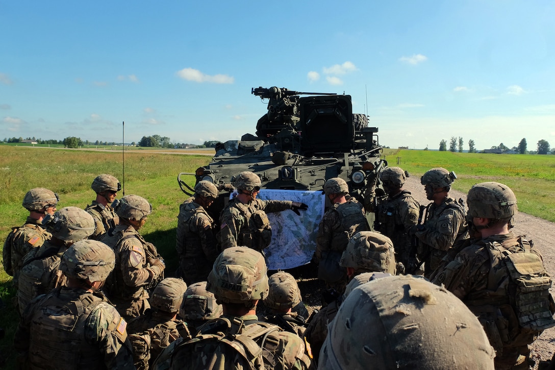 Army 1st Lt. Granath Musson, platoon leader, briefs Battle Group Poland soldiers on their fighting position location as part of the Bull Run training exercise in Suwalki, Poland, July 16, 2017. Army photo by Spc. Kevin Wang