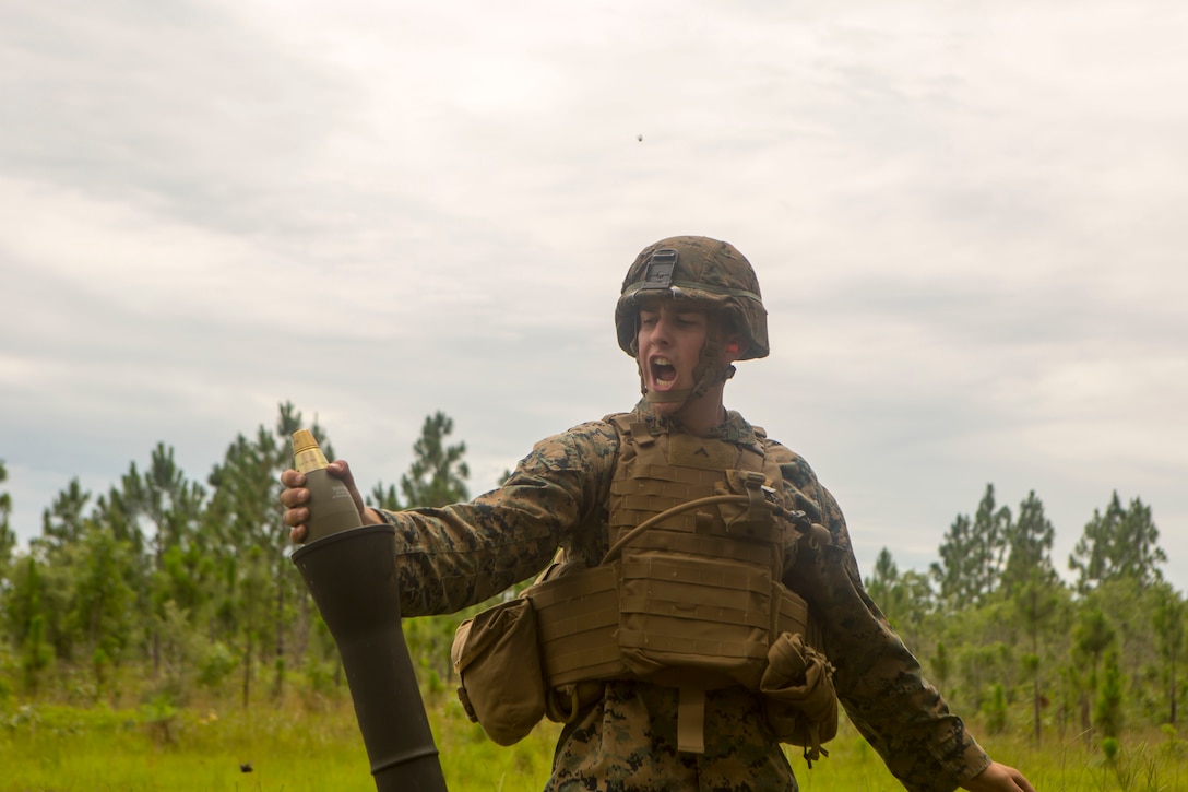 Pfc. Alexander Sapp prepares to fire an M821 mortar round during a training event at Camp Lejeune, North Carolina, June 21, 2017. The training event was held to allow Marines from 2nd Air Naval Gunfire Liaison Company the opportunity to conduct call for fire missions with artillery and mortar assets of other units. Sapp is a mortarman with 1st Battalion, 6th Marine Regiment. (U.S. Marine Corps photo by Lance Cpl. Damarko Bones)