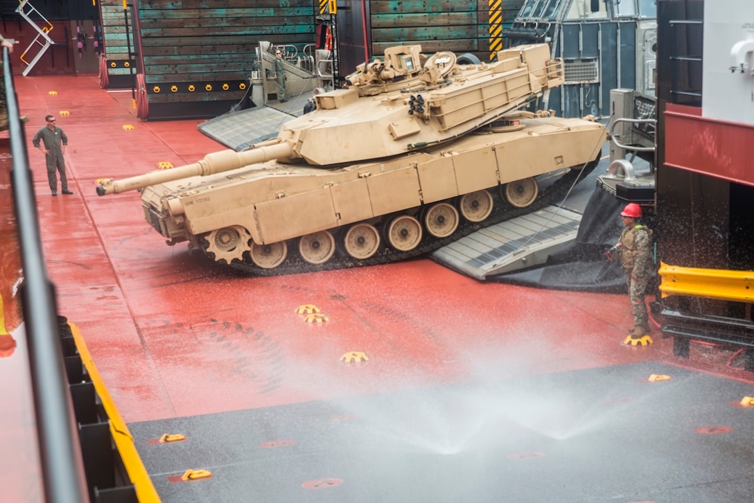 A U.S. Marine Corps M1A1 Abrams tank embarks the USNS John Glenn to be washed down during exercise Pacific Horizon, July 17, 2017. Pacific Horizon 2017 is a Maritime Prepositioning Force (MPF) exercise designed to train I Marine Expeditionary Force (MEF) and components of Naval Beach Group 1 (NBG-1) Marines and Sailors on arrival and assembly operations as well as follow-on Marine Air Ground Task Force actions to ensure that the right equipment, supplies and tools get to the right people to be employed in a crisis response, humanitarian assistance or amassing combat power ashore from sea. (U.S. Marine Corps photo by Sgt. Alvin Pujols)