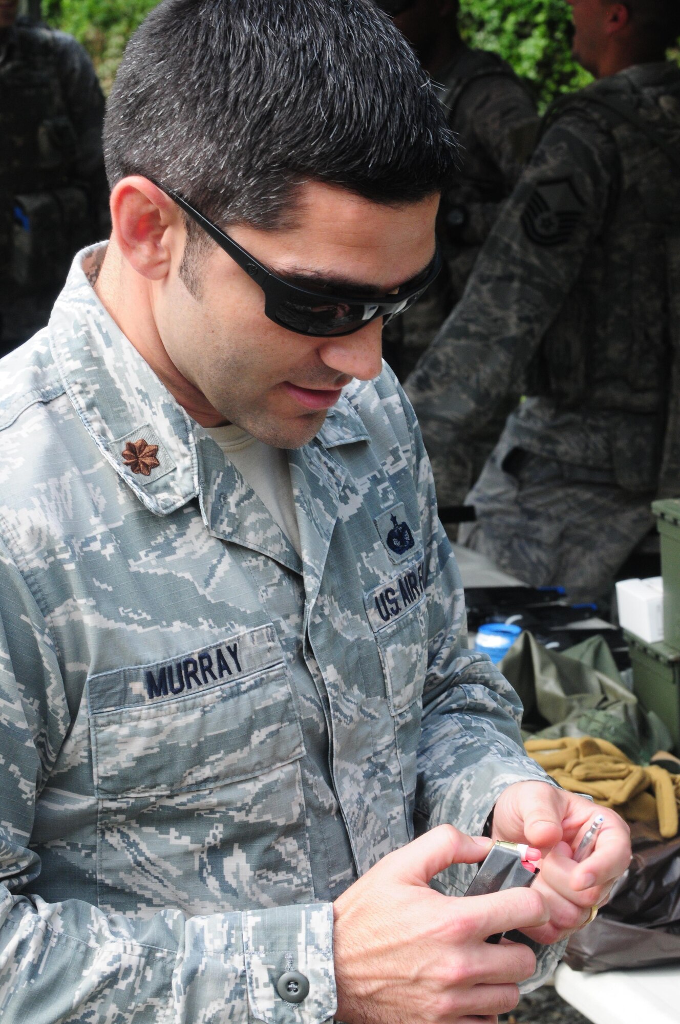 Maj. Samuel Murray, 916th Security Forces Squadron operations officer, removes simulated rounds from a magazine during “shoot, move and communicate” training on July 16, 2017, at Seymour Johnson Air Force Base, North Carolina. (U.S. Air Force photo by Senior Airman Jeramy Moore)