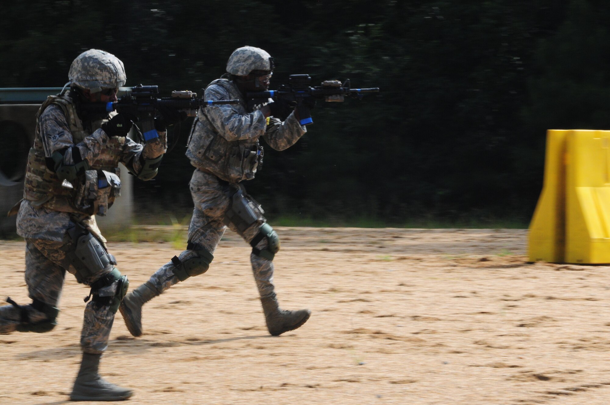 Members of the 916th Security Forces Squadron sprint into position during “shoot, move and communicate” training on July 16, 2017, at Seymour Johnson Air Force Base, North Carolina. (U.S. Air Force photo by Senior Airman Jeramy Moore)