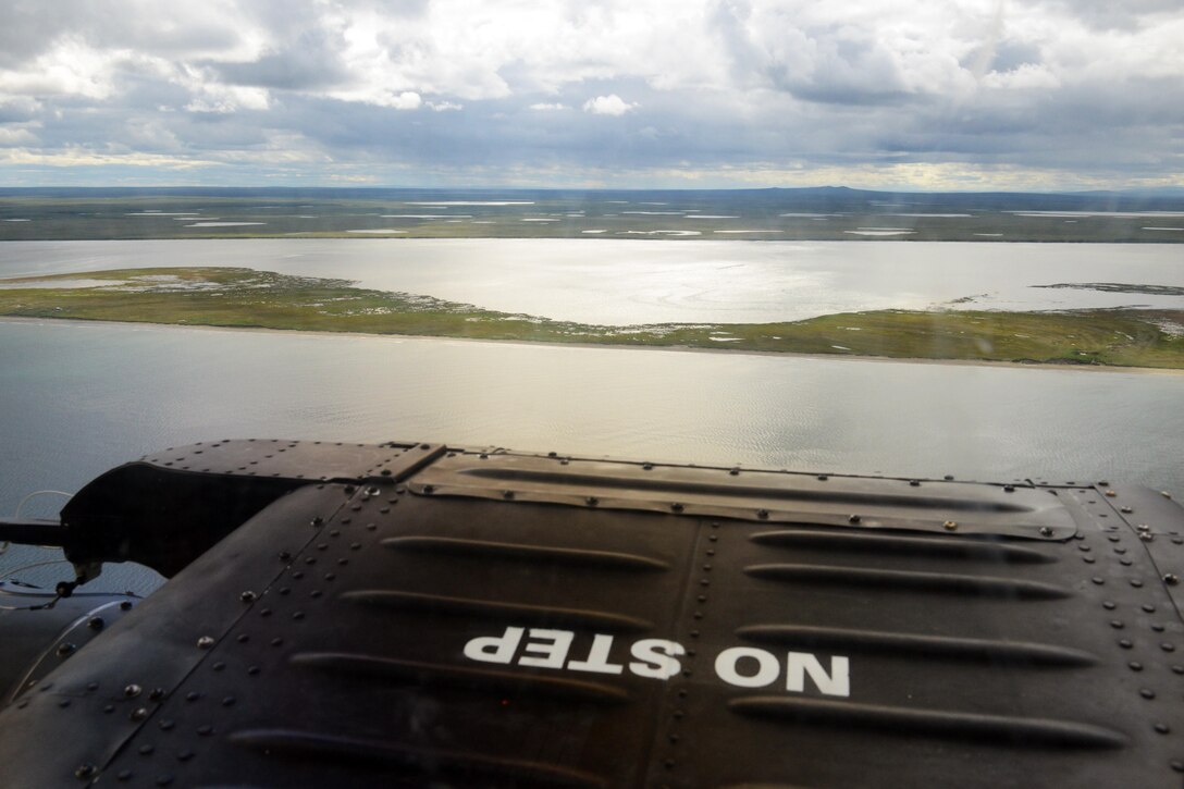 An MH-60 Jayhawk assigned to Coast Guard Air Station Kodiak flies along the coastline of Kotzebue Sound during Operation Arctic Shield in Kotzebue, Alaska, July 16, 2017. Coast Guard photo by Lt. Brian Dykens