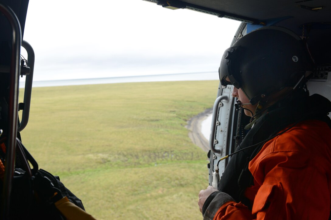 Coast Guard Petty Officer 2nd Class Adam Campbell, an aircrewman aboard an MH-60 Jayhawk helicopter, monitors a landing during area-familiarization training in northwestern Alaska as part of Operation Arctic Shield in Kotzebue, Alaska, July 16, 2017. Coast Guard photo by Lt. Brian Dykens