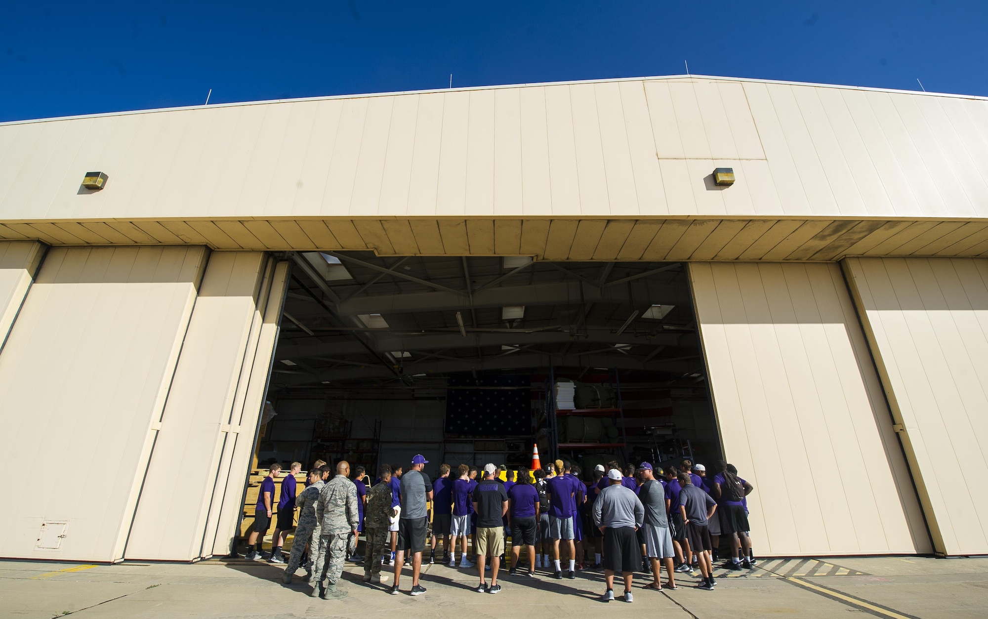 Clovis High School football players crowd around a display set up by the 26th Special Tactics Squadron during the team’s tour at Cannon Air Force Base, NM, July 19, 2017.The football team visited the 26th STS to learn about their job and culture. (U.S. Air Force photo by Senior Airman Lane T. Plummer)