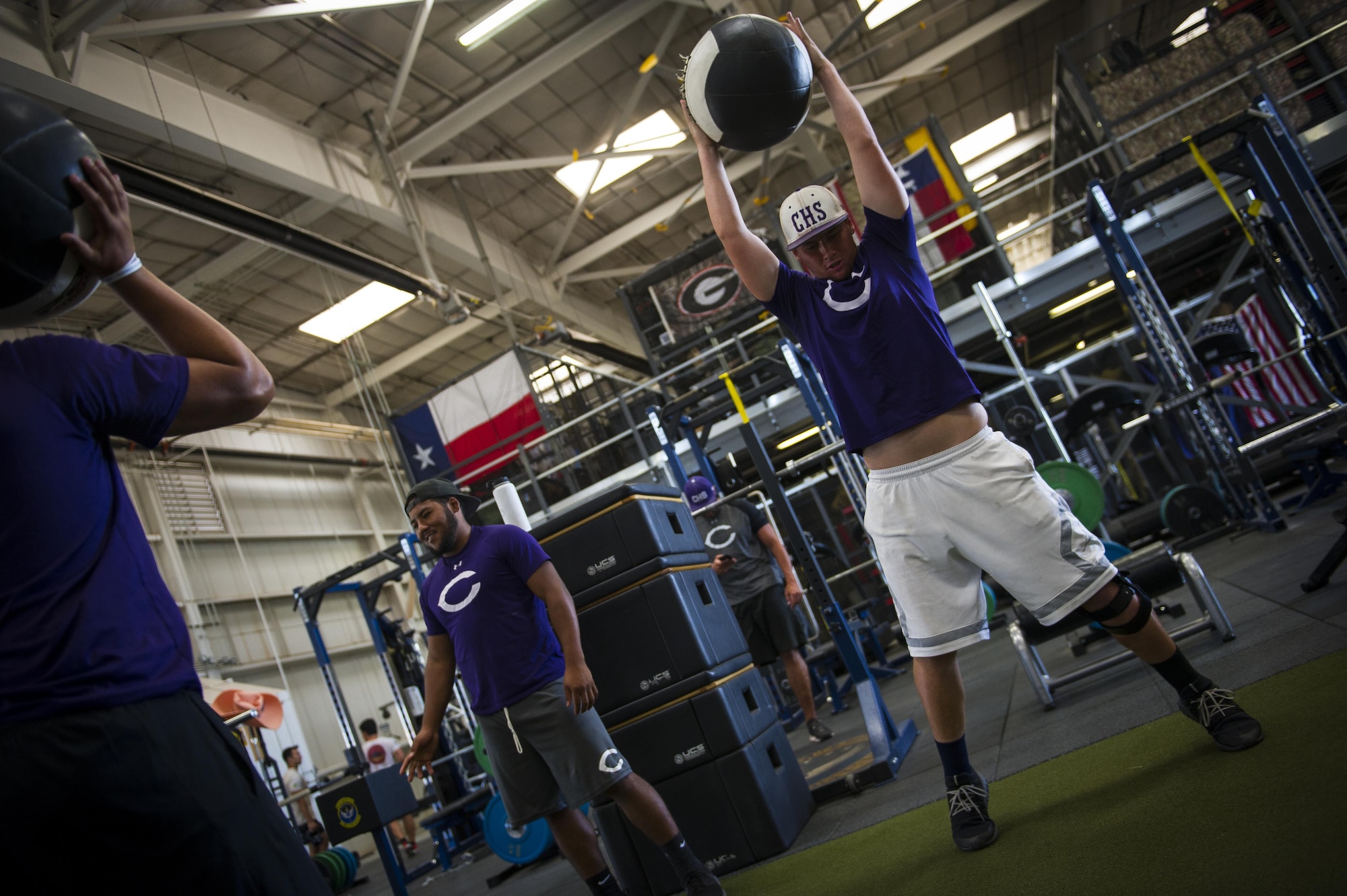 Clovis High School football players exercise at the 26th Special Tactics Squadron’s gymnasium during their tour at Cannon Air Force Base, NM, July 19, 2017. Students followed a regimen constructed and used by 26th STS Airmen in what one of them describes as a “world class facility.” (U.S. Air Force photo by Senior Airman Lane T. Plummer)