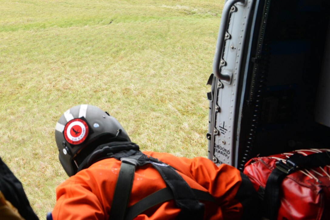 Coast Guard Petty Officer 2nd class Adam Campbell, an aircrewman aboard an MH-60 Jayhawk helicopter, monitors a takeoff during area-familiarization training in northwestern Alaska as part of Operation Arctic Shield in Kotzebue, Alaska, July 16, 2017. Coast Guard photo by Lt. Brian 