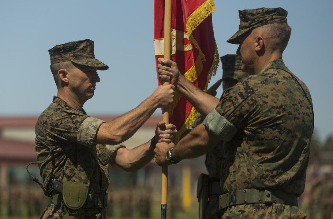 Lt. Col. Seth E. Anderson (right) passes the 1st Intelligence Battalion’s organizational colors to Lt. Col. B.J. Grass (left) during a change of command ceremony at Camp Pendleton, Calif. June 21, 2017. Grass was the executive officer at the Marine Corps Intelligence schools, Va., and Anderson will attend the U.S. Army War College in Carlisle, Pa. (U.S. Marine Corps photo by Lance Cpl. A. J. Van Fredenberg)