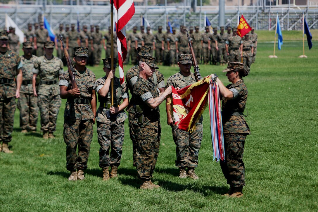 Col. Bobbi Shea begins casing the I Marine Expeditionary Force Headquarters Group organizational colors to symbolize the re-designation of I MHG to I MEF Information Group July 6, 2017, at Camp Pendleton, Calif. During the ceremony I MEF Headquarters Group was re-designated as I MIG to support I Marine Expeditionary Force in the expanding information environment. (U.S. Marine Corps photo by Lance Cpl. Robert A Alejandre)