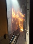 An apartment building on fire in L'viv, Ukraine, on July 16, 2017. Soldiers with the Oklahoma Army National Guard’s 45th Infantry Brigade Combat Team, deployed to Ukraine in support of the Joint Multinational Training Group-Ukraine, rushed into the burning building and evacuated the third floor before  firefighters arrived.