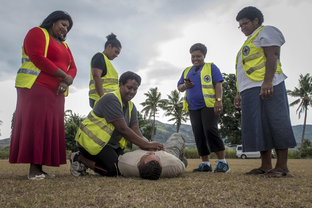 Air Force Senior Airman Chris Rodgers teaches Fijian health care volunteers the basics of CPR during hands-on training as part of Pacific Angel 17-3 at Tagitagi Sangam School and Kindergarten in Tavua, Fiji, July 15, 2017. Air Force photo by Tech. Sgt. Benjamin W. Stratton