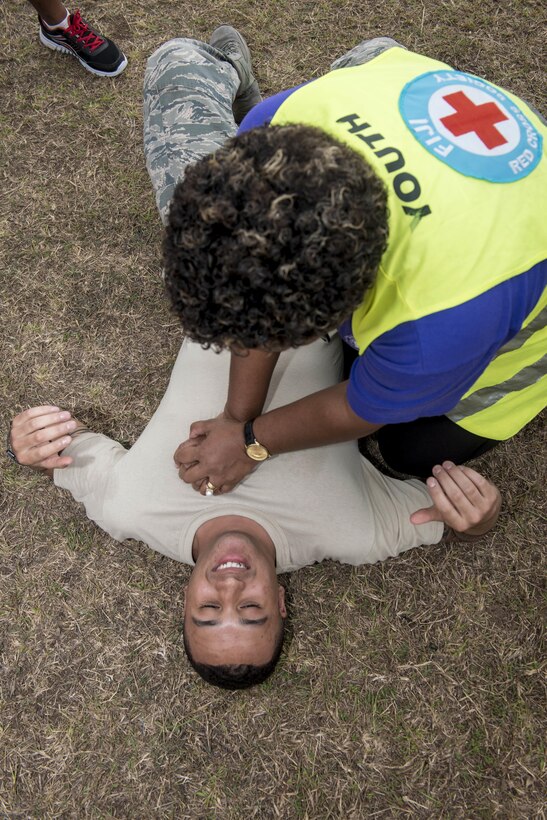 A Fijian health care volunteer presses down on Air Force Senior Airman Chris Rodgers while practicing the basics of CPR during hands-on training as part of Pacific Angel 17-3 at Tagitagi Sangam School and Kindergarten in Tavua, Fiji, July 15, 2017. Rogers is an aerospace medical service journeyman assigned to the 35th Medical Operations Squadron at Misawa Air Base, Japan. Air Force photo by Tech. Sgt. Benjamin W. Stratton