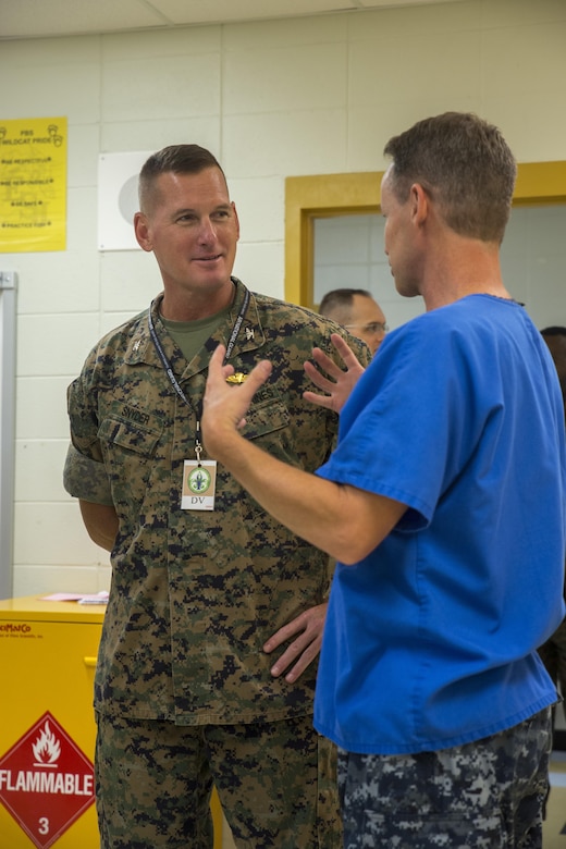 Navy Capt. Roddy E. Miller, the senior dental expert with Expeditionary Medical Facility Camp Pendleton, talks to Marine Col. Christopher B. Snyder, the chief of staff for 4th Marine Logistics Group, Marine Forces Reserve, at East Saint John High School in Reserve, La. for Innovative Readiness Training Louisiana Care 2017, July 15, 2017. MARFORRES units like 4th Dental Battalion, 4th MLG are working closely with other medical units and services from across the country to provide medical, dental and optometry care to the local community at no cost to patients. (U.S. Marine Corps photo by Lance Cpl. Niles Lee/Released) 