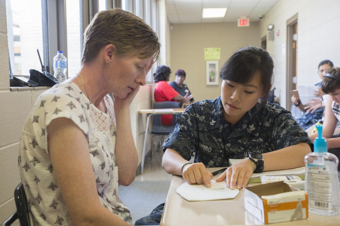 Petty Officer 2nd Class Crystal Tao, a hospital corpsman with Expeditionary Medical Facility Camp Pendleton, tests the eyesight of Kathleen Giles, a patient attending Innovative Readiness Training Louisiana Care 2017, at Amite High School in Amite, La., July 15, 2017. IRT Louisiana Care 2017 offers optometry, dental and medical care to the local community at no cost to patients. (U.S. Marine Corps Photo by Lance Cpl. Niles Lee/Released) 