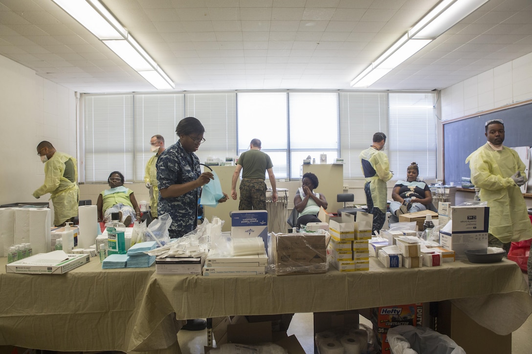 Navy personal with 4th Dental Battalion, 4th Marine Logistics Group, Marine Forces Reserve and Expeditionary Medical Facility Camp Pendleton, prepare for dental procedures at Amite High School in Amite, La., during Innovative Readiness Training Louisiana Care 2017, July 15, 2017. MARFORRES units like 4th Dental Battalion are working closely with other medical units and services from across the country to provide medical, dental and optometry care to the local community at no cost to patients. (U.S. Marine Corps photo by Lance Cpl. Niles Lee/Released) 