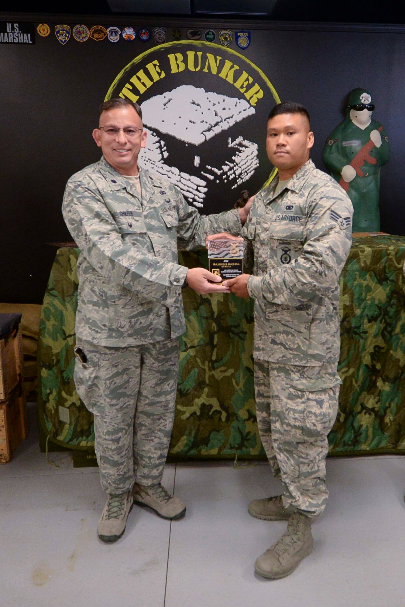 Lt. Col. Brian Griefer, Operations and Training Branch Chief, NCB/A4S present the Air National Guard Security Forces 2016 Unit of the Year award to Senior Airman Jason Daquinas, 129th Security Forces, during an awards ceremony at Moffett Air National Guard Base, Calif., July 18, 2017. (U.S.Air National Guard photo by Senior Airman Zachiah Roberson/released)