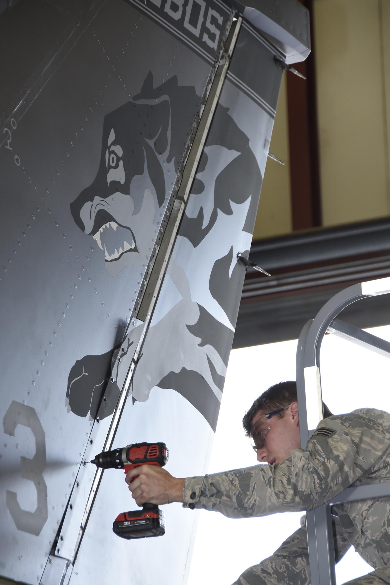 Senior Airman Nicholas Jones, 114th Aircraft Maintenance Squadron sheet metal mechanic, removed a panel from the tail of an F-16 during the de-paneling Phase of a phase maintenance inspection at Joe Foss Field, July 8, 2017.  Each aircraft is required to go through a phase inspection every 400 flight hours to ensure all systems are functioning with in Air Force regulations.  (U.S. Air National Guard photo by Master Sgt. Christopher Stewart/Released)