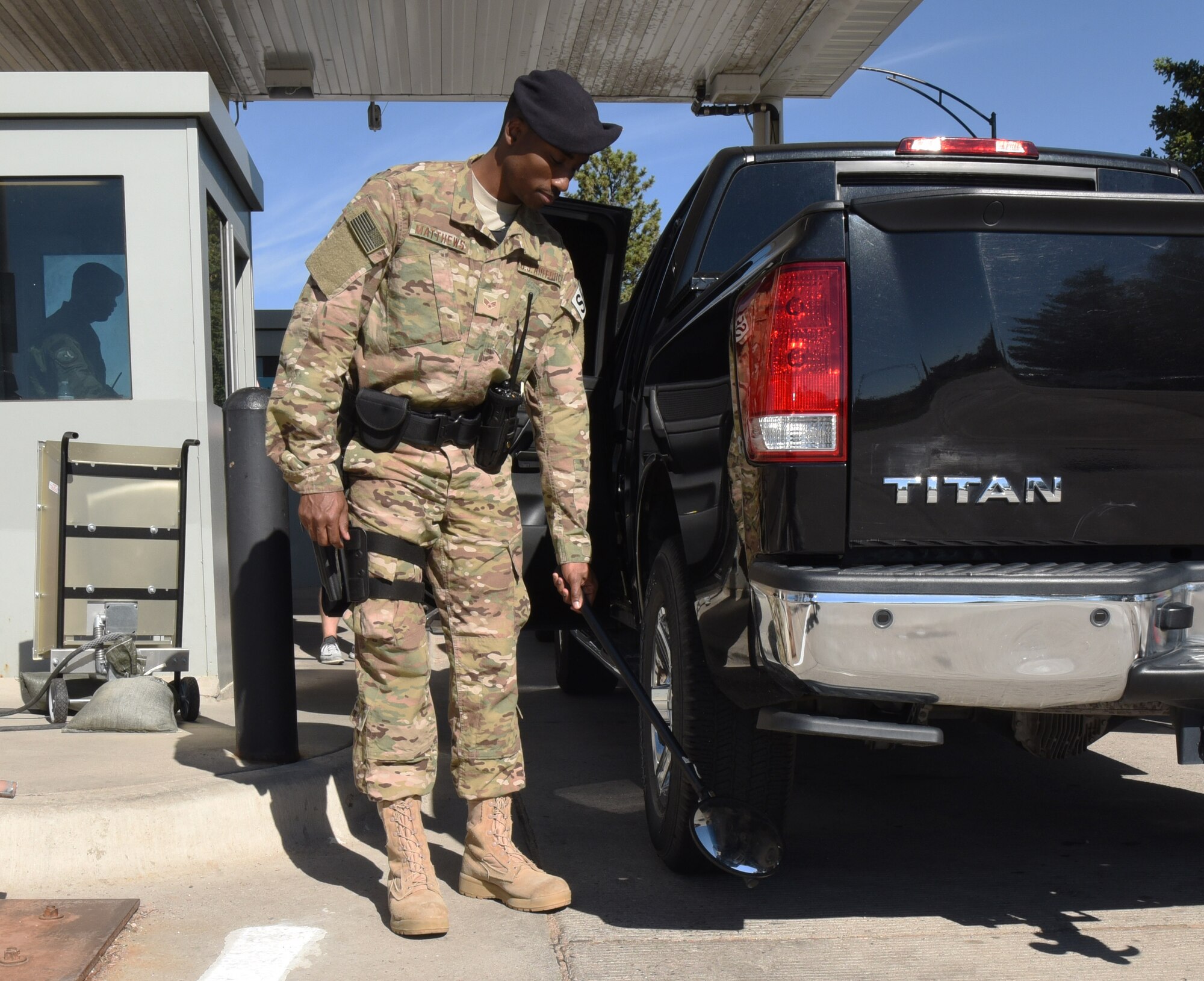 Senior Airman Markus Matthews, 90th Security Forces Squadron entry controller, conducts a random vehicle inspection at F.E. Warren Air Force Base, Wyo., July 14, 2017. The checks are performed as a random anti-terrorism measure to ensure the safety of the installation and its personnel. (U.S. Air Force photo by Airman 1st Class Breanna Carter)