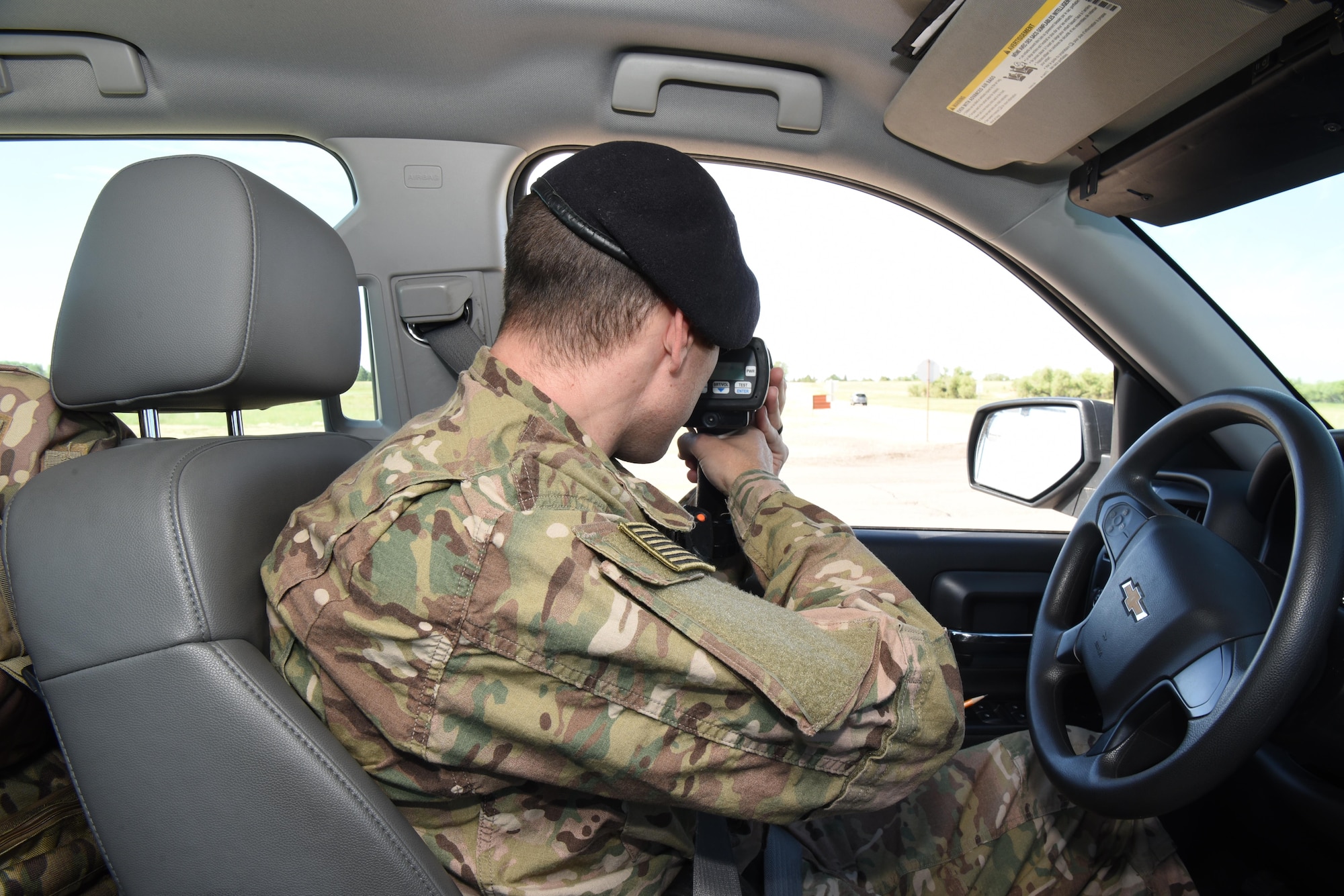 Staff Sgt. Charles Watson, 90th Security Forces Squadron patrolman, check drivers' speed using a laser gun at F.E. Warren Air Force Base, Wyo., July 14, 2017. Trafficking enforcement is one of the many ways the 90th SFS defenders maintain the safety of the installation's personnel. (U.S. Air Force photo by Airman 1st Class Breanna Carter)